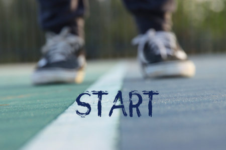 View of shoes on asphalt with the word start. Concept of new challenge and moving forwardの写真素材