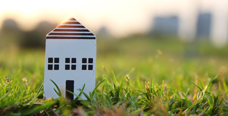 Concept image of a small house in nature. Idea of ecology, solar energy, and sustainabilityの写真素材