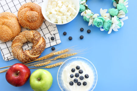 Photo of bread and dairy products over blue background. Symbols of jewish holiday - Shavuotの写真素材