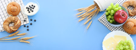 Photo of bread and dairy products over blue background. Symbols of jewish holiday - Shavuotの写真素材