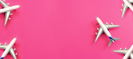 Top view of pink background and airplane. Concept of travel, vacation