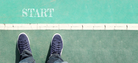 View of shoes on asphalt with the word start. Concept of new challenge and moving forwardの写真素材