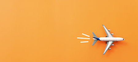 Top view of orange background and airplane. Concept of travel, vacationの写真素材