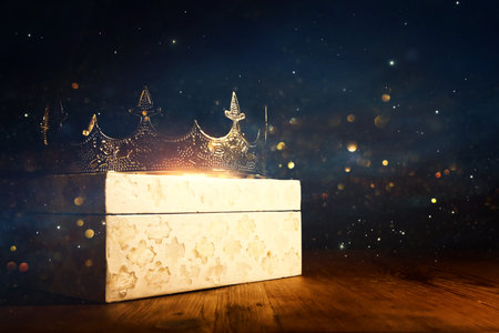 low key image of beautiful queen or king crown over wooden table. vintage filtered. fantasy medieval periodの写真素材