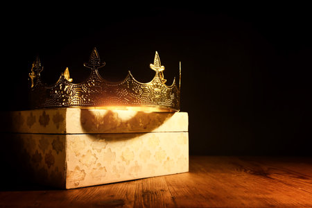 low key image of beautiful queen or king crown over wooden table. vintage filtered. fantasy medieval periodの写真素材