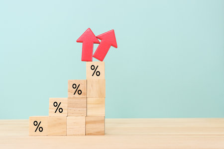 Wooden cubes with percentage sign going up, concept of business growth, finance and income increaseの写真素材