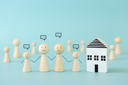 Concept image of family, communication and home. Wooden figures and speech bubblesの写真素材