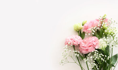 Top view image of pink flowers composition over white backgroundの写真素材