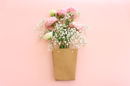 Top view image of delicate pink flowers over pastel backgroundの写真素材