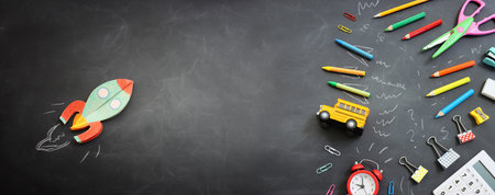 Back to school concept. rocket, bus and pencils over classroom blackboard. Top viewの写真素材