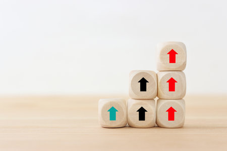 Arrows on wooden blocks, idea of thinking differently, setting goals and thinking about solutionの写真素材
