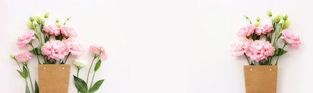 Top view image of pink flowers composition over white backgroundの写真素材