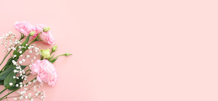 Top view image of delicate pink flowers over pastel backgroundの写真素材