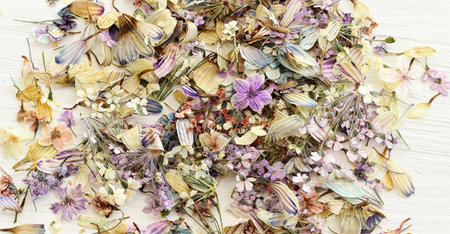 Top view image of dry flowers over wooden white background .Flat lay
