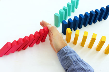 stopping the domino effect. executive and risk control concept