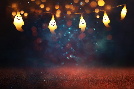 holidays concept of Halloween. Glitter background with colorful garland lights