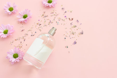 Image of clean elegant perfume bottle over pink pastel backgroundの写真素材