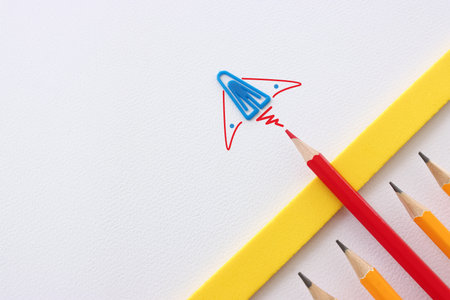 Concept image of unique thinking. Paper clips in the shape of airplane. Idea of teamwork and...