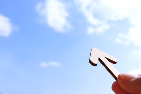 Arrow sign pointing ahead to the sky. Concept of challenge and looking forwardの写真素材