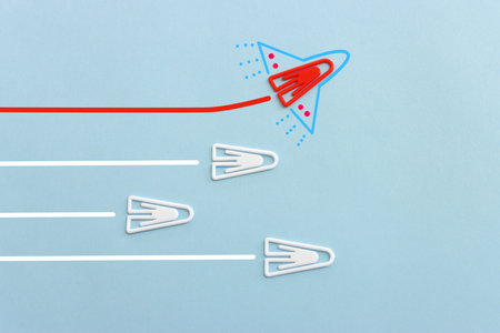 Concept image of unique thinking. Paper clips in the shape of airplane. Idea of teamwork and leadershipの写真素材