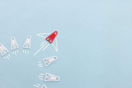 Concept image of unique thinking. Paper clips in the shape of airplane. Idea of teamwork and leadershipの写真素材