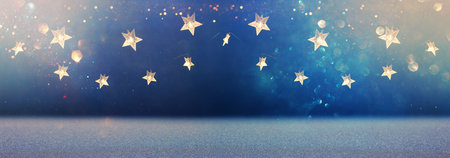 Christmas warm gold garland lights over dark background with glitter overlay