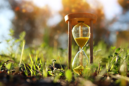 Hourglass in nature. Idea of ecology, time and preserving the earthの写真素材