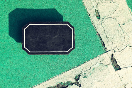 Top view image of empty blackboard sign on textured floorの写真素材