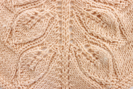 background of beige crochet ornament made of wool