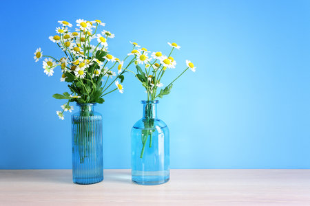 spring bouquet of daisies flowers over wooden table and mint patel backgroundの写真素材
