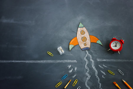 rocket overcoming barrier obstacle. Blackboard backgroundの写真素材