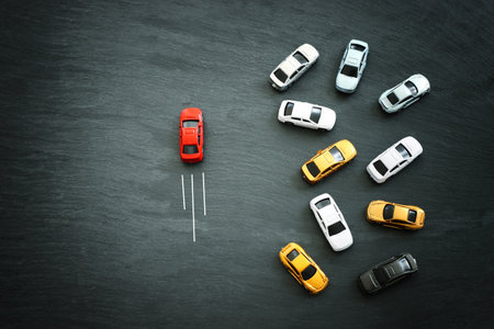 Concept image of challenge and teamwork. Red car leading the groupの写真素材