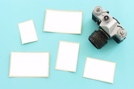 top view of blank photo frames over pastel blue background.の写真素材