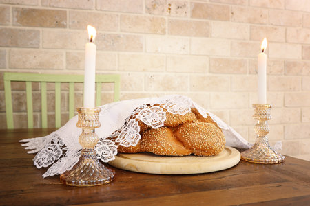 shabbat image. challah bread and candles on wooden tableの写真素材