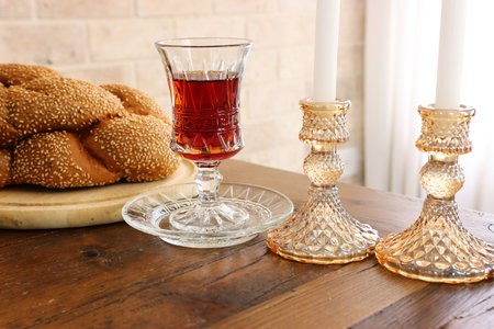 Shabbat image. challah bread, wine and candles on wooden tableの写真素材
