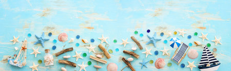 nautical concept with starfish and seashells over old wooden blue background. banner