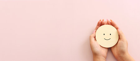 Concept image of satisfaction level. wooden cube with happy faceの写真素材