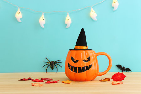 holidays image of Halloween. pumpkin cup over wooden tableの写真素材