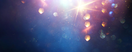 background of abstract glitter lights. gold, blue and black. de focused