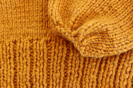 abstract background of yellow knitting texture made of wool