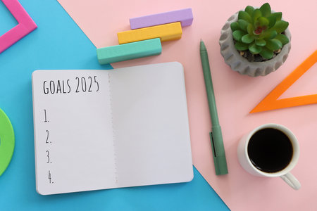 Top view image of notebook with the text goals 2025