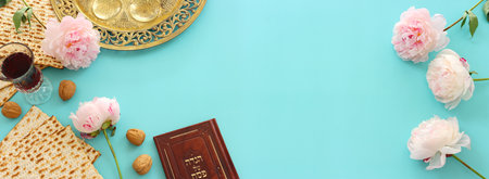 Pesah celebration concept (jewish Passover holiday). Traditional book with text in hebrew: Passover...