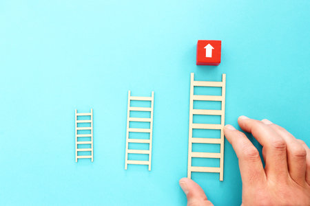 Male hand picking ladder. Concept of success growth and vision