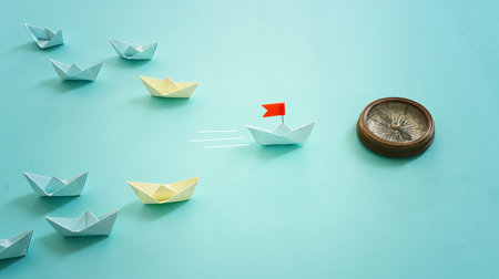 Paper boats following ahead of the leader with red flag