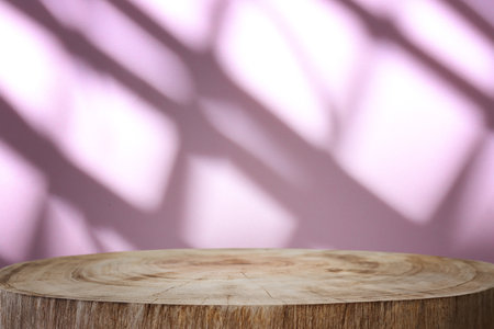 image of a wooden table and bright pink textured backgroundの写真素材
