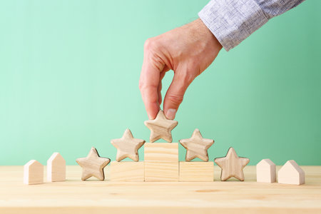 Hand picking small house and five star concept. Idea of high rating and service