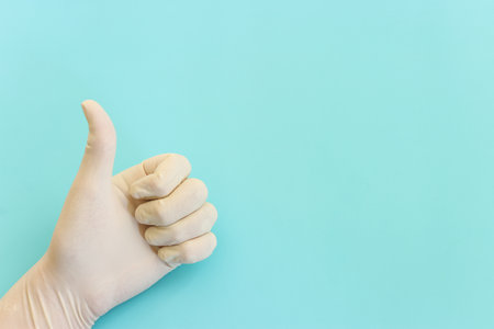 Top view image of hand with gloves over blue backgroundの写真素材
