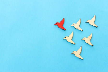 Concept image of birds following the leader. Idea of teamwork and moving aheadの写真素材