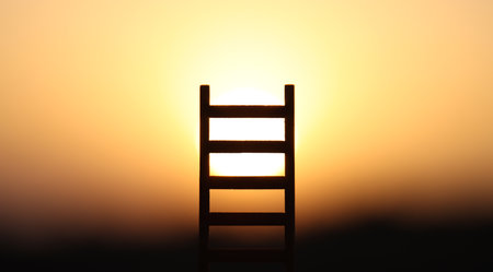 Ladder in nature in front of bright sunlight. Concept of freedom and successの写真素材