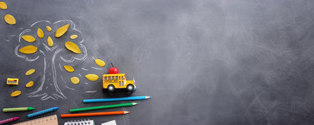Back to school concept over classroom blackboard. Top view